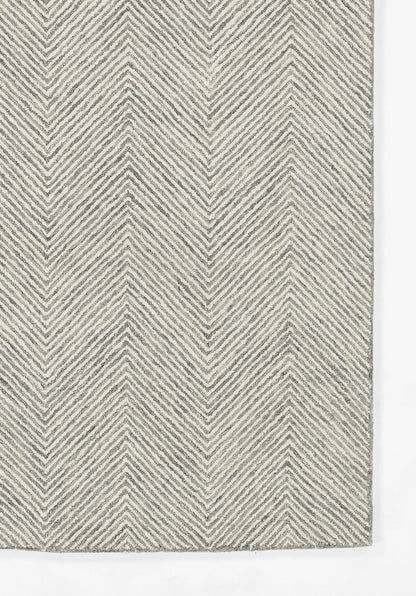Rectangular charcoal gray rug with a woven chevron herringbone pattern in light and dark gray tones.