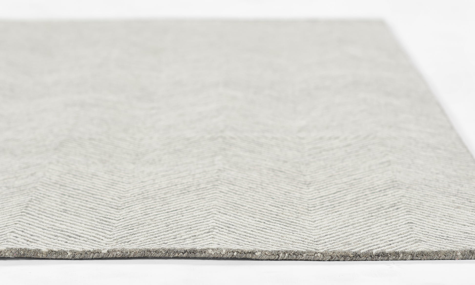 Light gray chevron-pattern rug, woven fabric, rectangular, modern style for living room or hallway.