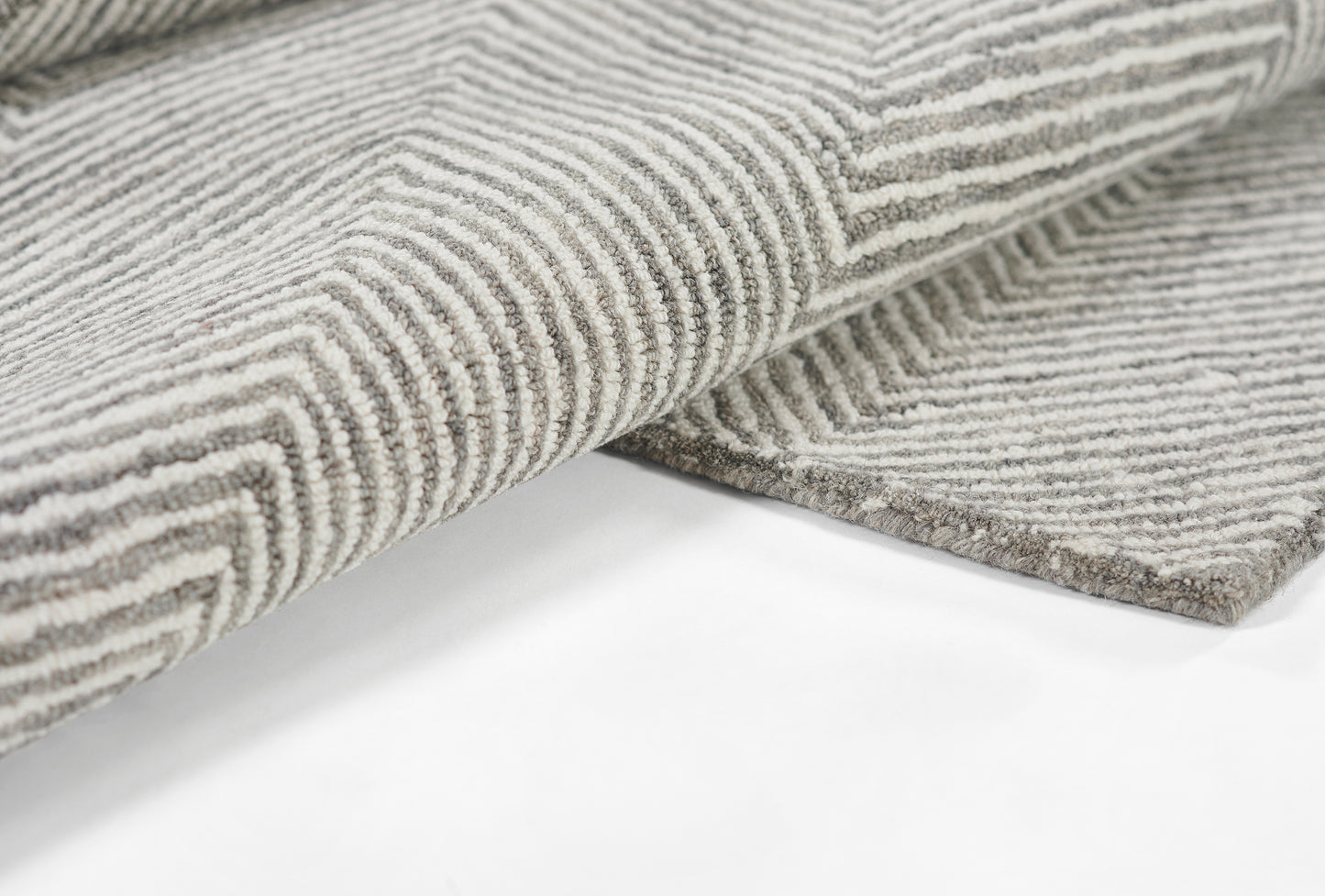 Charcoal gray & white striped rug with geometric chevron pattern and plush looped pile.