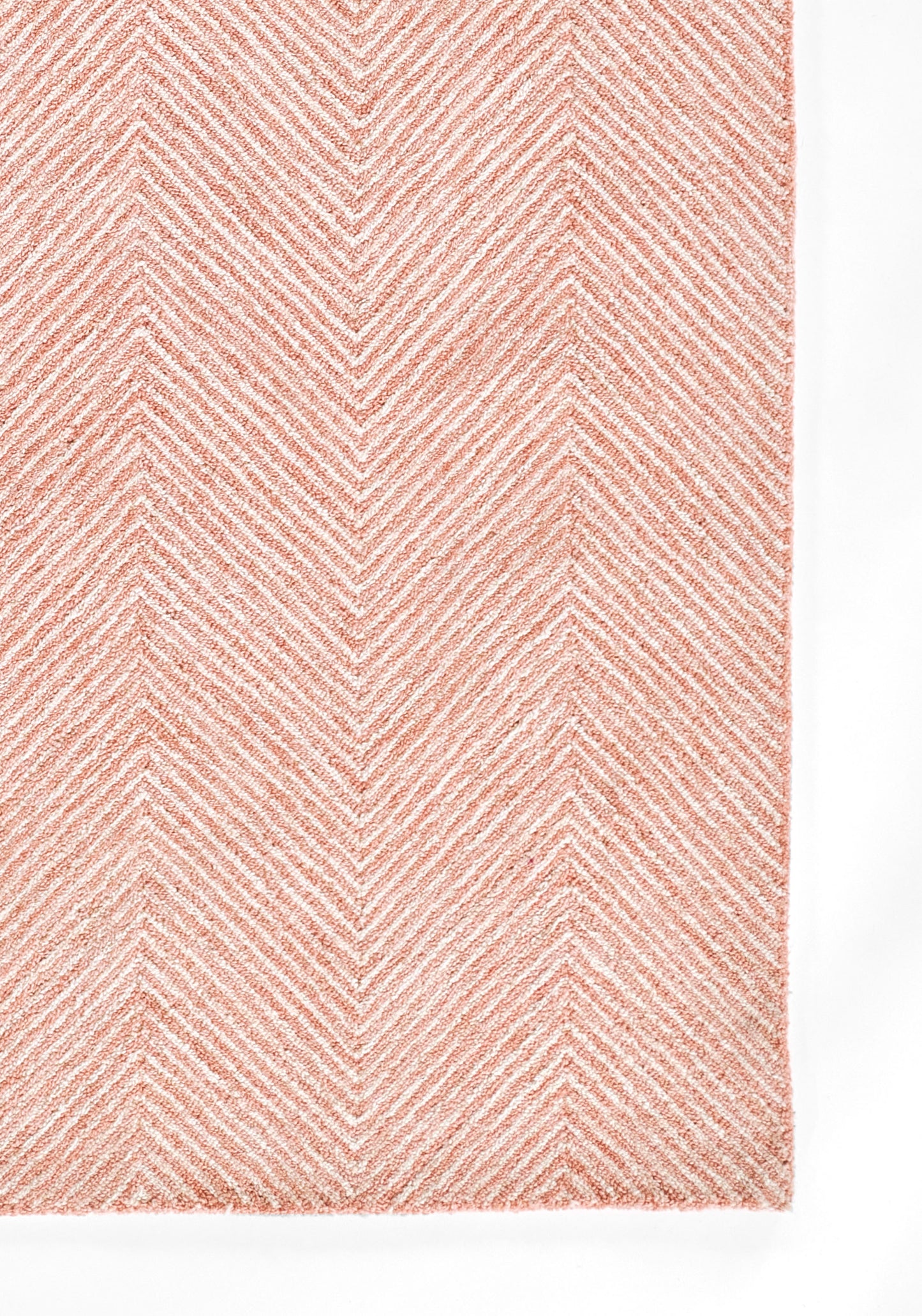 Soft pink rug with white chevron herringbone pattern and plush textured pile.