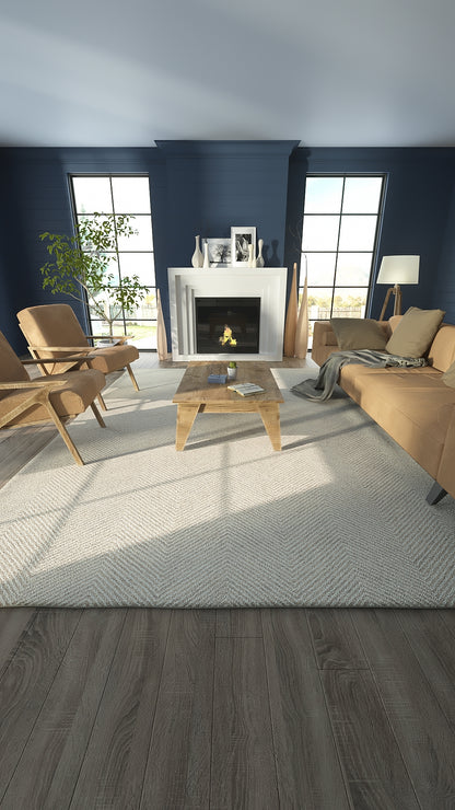 Taupe fabric sofa with matching armchairs, wooden coffee table, blue walls, white fireplace, and large windows.
