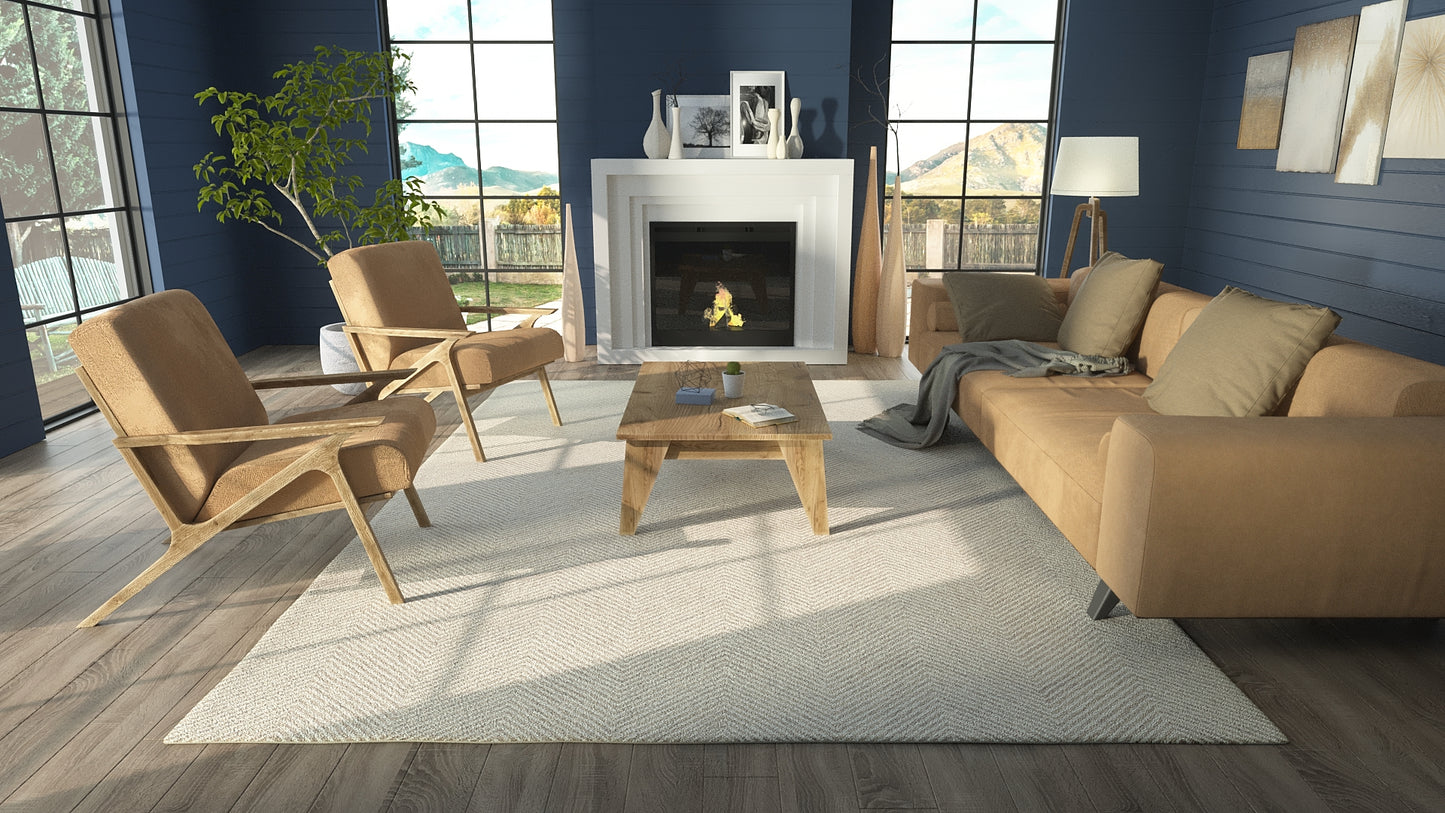 Taupe fabric sofa with wooden-frame chairs in a modern living room with blue walls, fireplace, and large windows.