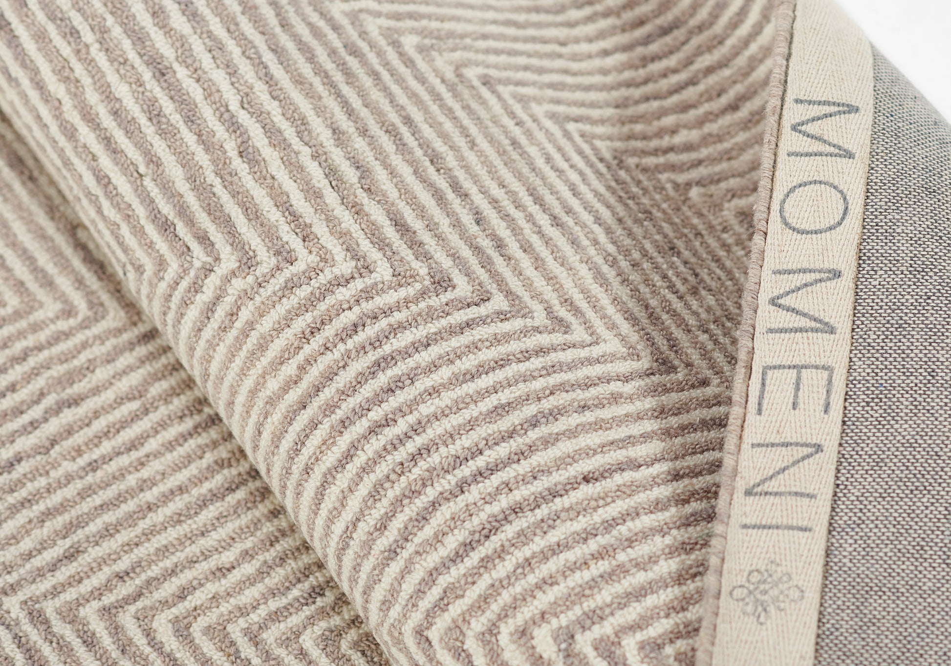 Beige taupe chevron-textured rug runner with raised ridges and a beige edge ribbon, size 2'3" x 8'.