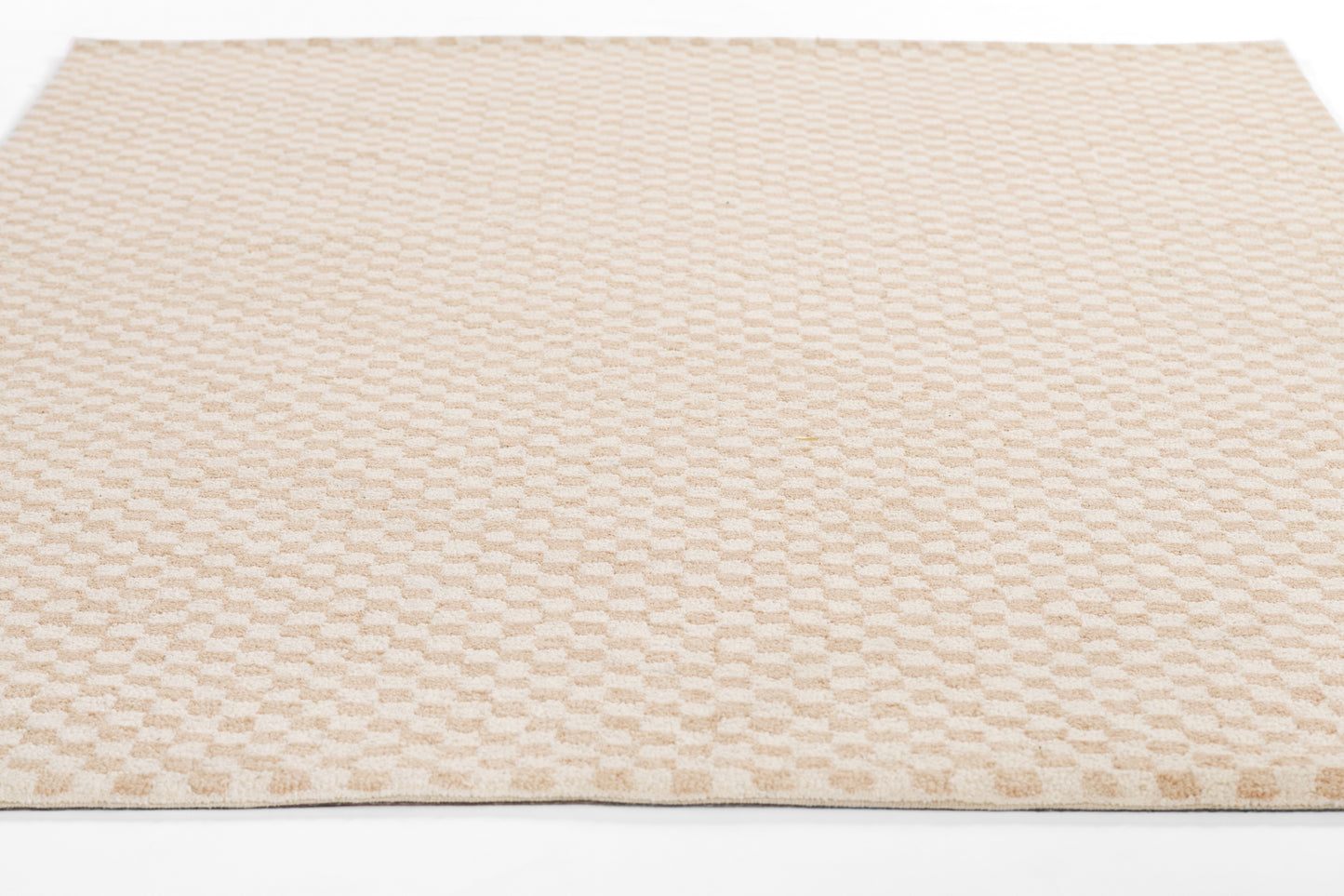 Beige textured area rug with a subtle repeating raised dot pattern in soft, neutral tones.