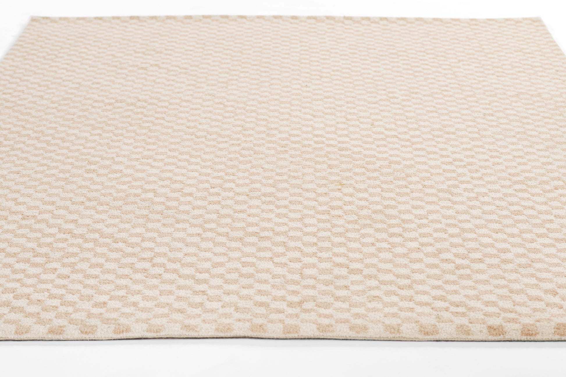 Beige plush area rug with a repeating rounded-square pattern, soft chenille texture, rectangular shape.