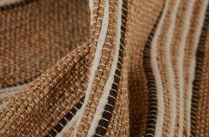 Brown and cream woven textile with striped pattern and chunky fringe, rustic rug or throw fabric.