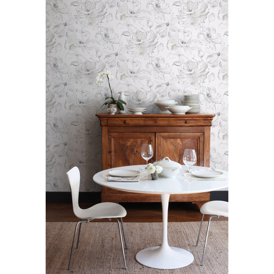 Soft grey floral wallpaper featuring large loosely sketched blossoms, delicate botanical details, and subtle neutral shading on a crisp white background. Floral Dreams Wallpaper by York Wallcoverings brings an airy, sophisticated feel to bedrooms, dining rooms, powder rooms, home offices, entryways, cottage interiors, and neutral home decor.