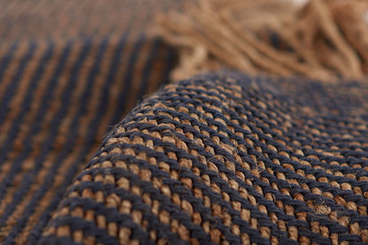 Close-up of navy blue and natural tan braided jute weave on a 2' x 8' rug runner with thick textured fibers.