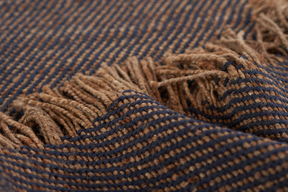 Navy blue and tan woven rug with fringed edges, rustic striped pattern, 5' x 8'.