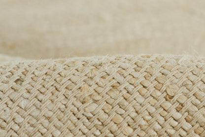 Close-up of natural straw weave with tight braiding in beige tones.
