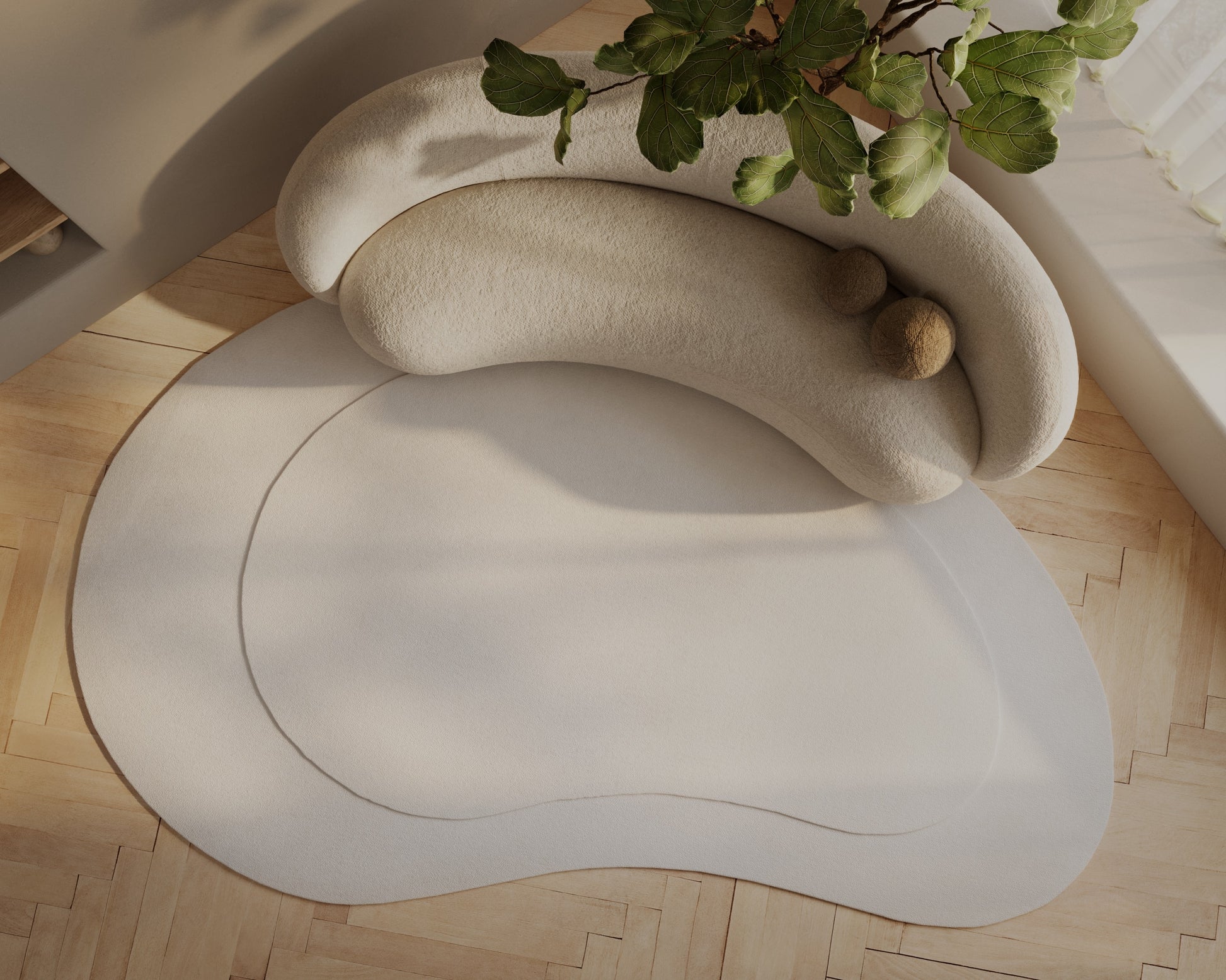 Cream curved modular sofa cushions in plush fabric on a pale circular rug; modern cozy lounge setup with a green plant.