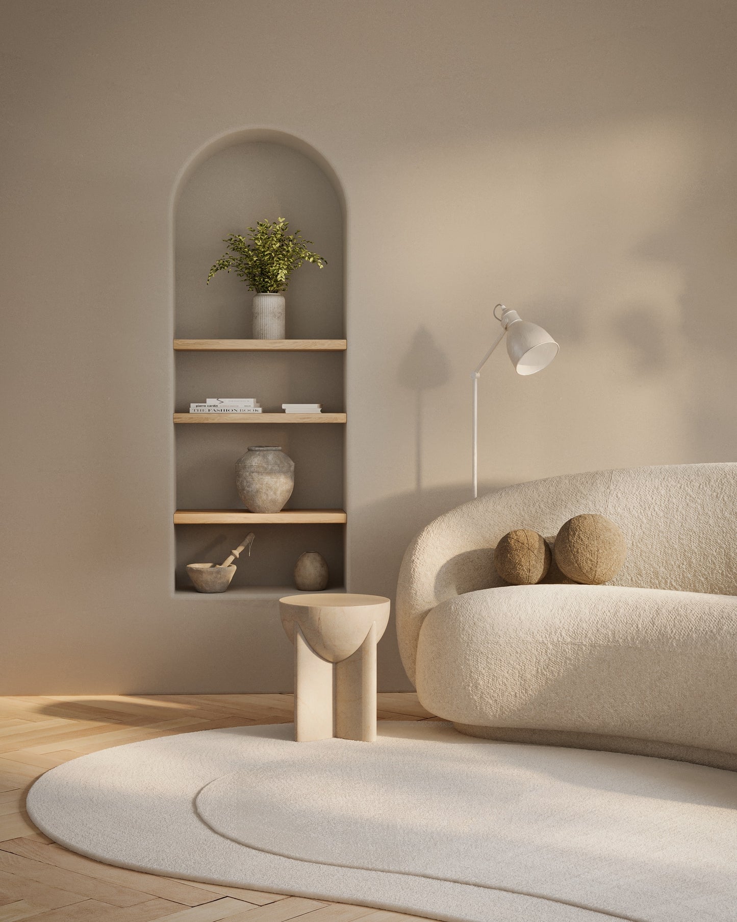 Ivory boucle sofa with rounded arms in a neutral living room featuring arched built-in shelves, wood accents, plant, and curved rug.