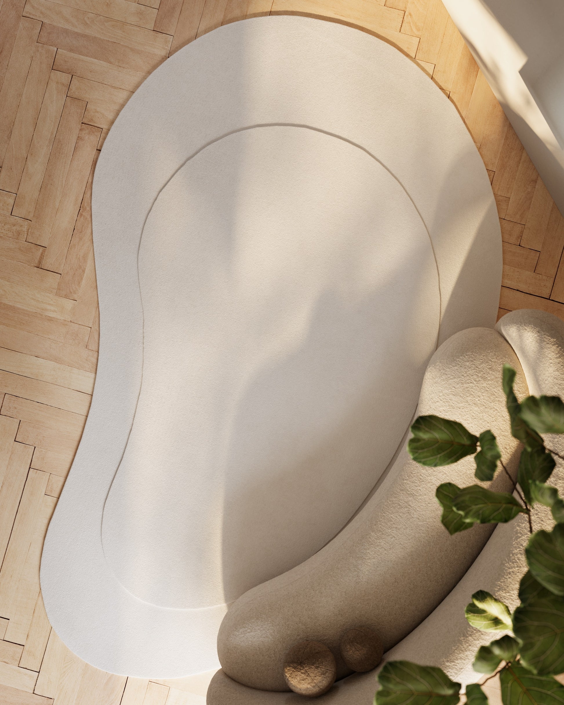 Ivory curved area rug on light wood floor; modern minimalist style with plush texture.