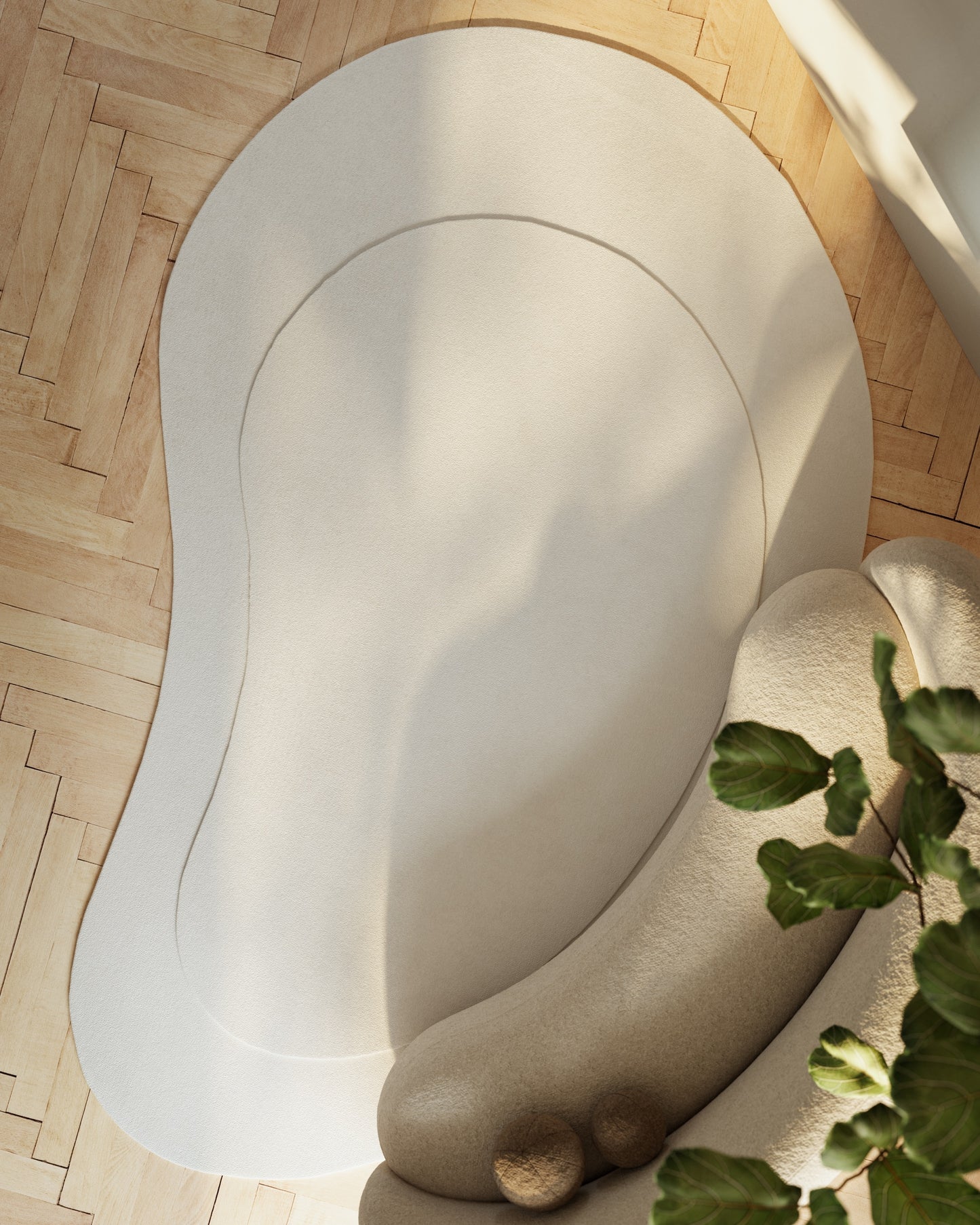 Ivory kidney-shaped area rug with subtle inner outline on light wood floor; sunlit corner with a leafy plant.