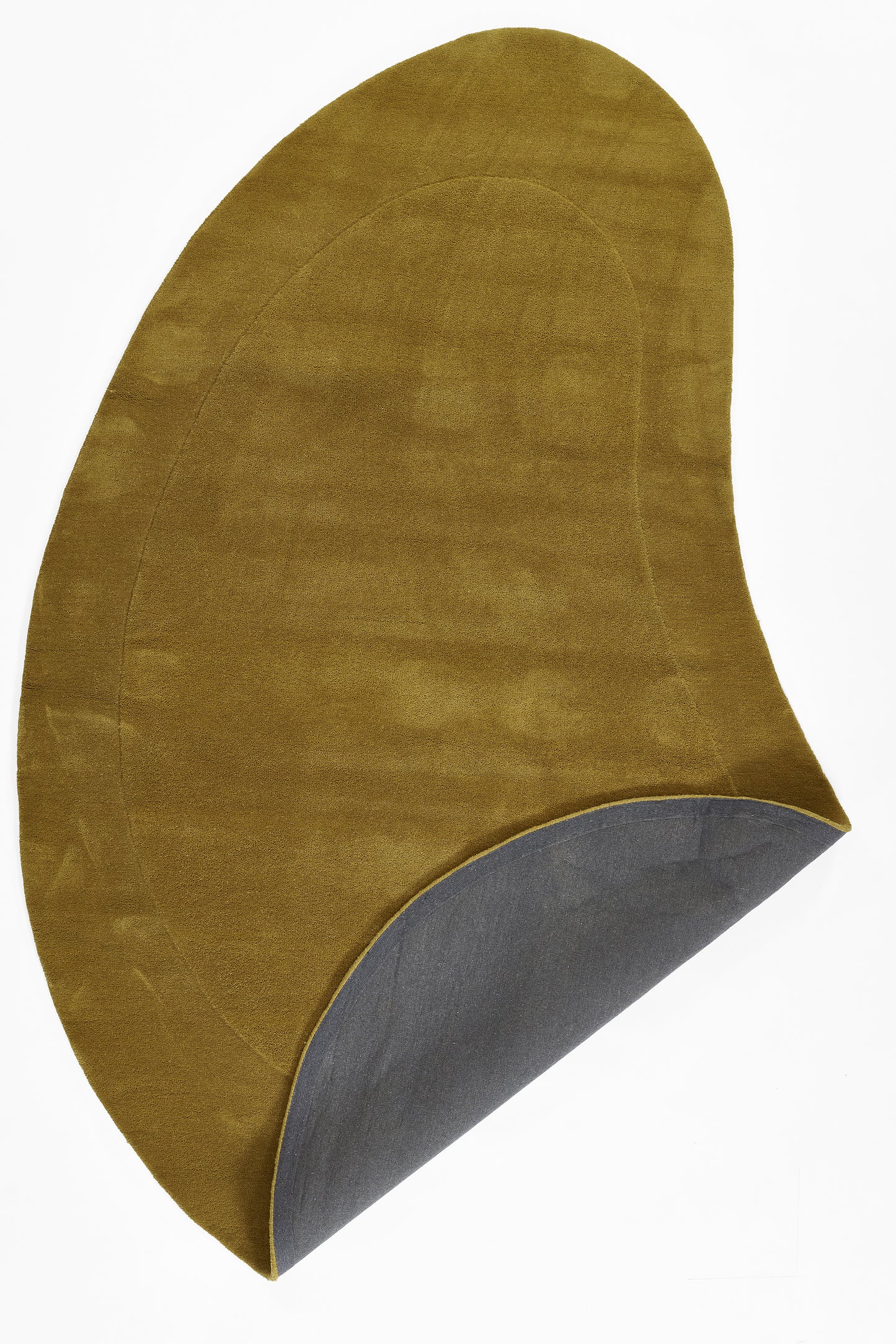 Mustard suede-like curved cushion with gray underside; modern arc shape for lounge, back rest or footrest.