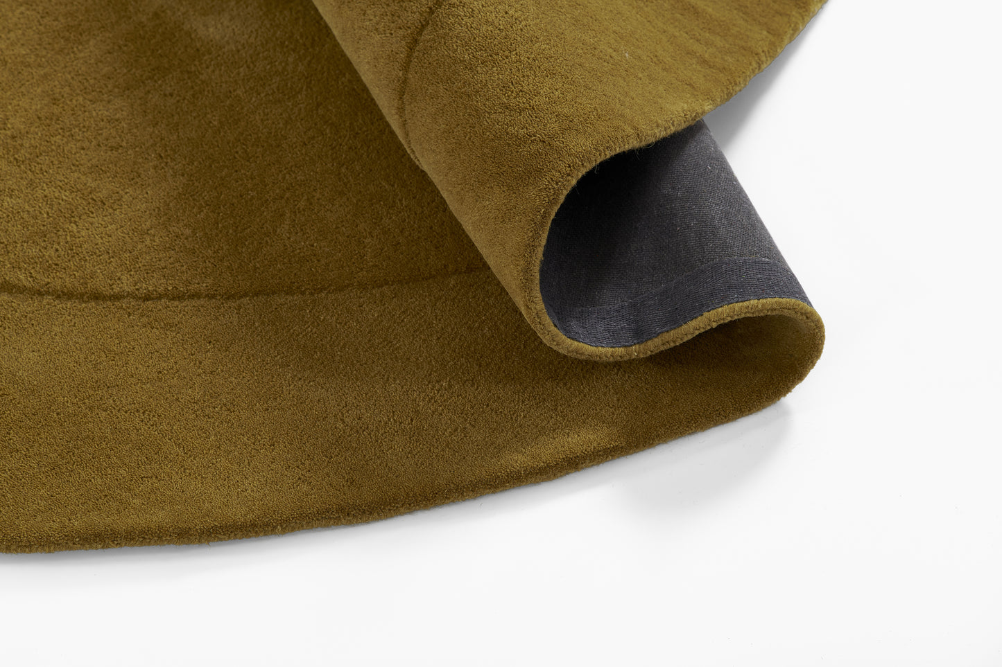 Olive-brown suede-textured fabric with dark navy lining peeking from a curved edge.