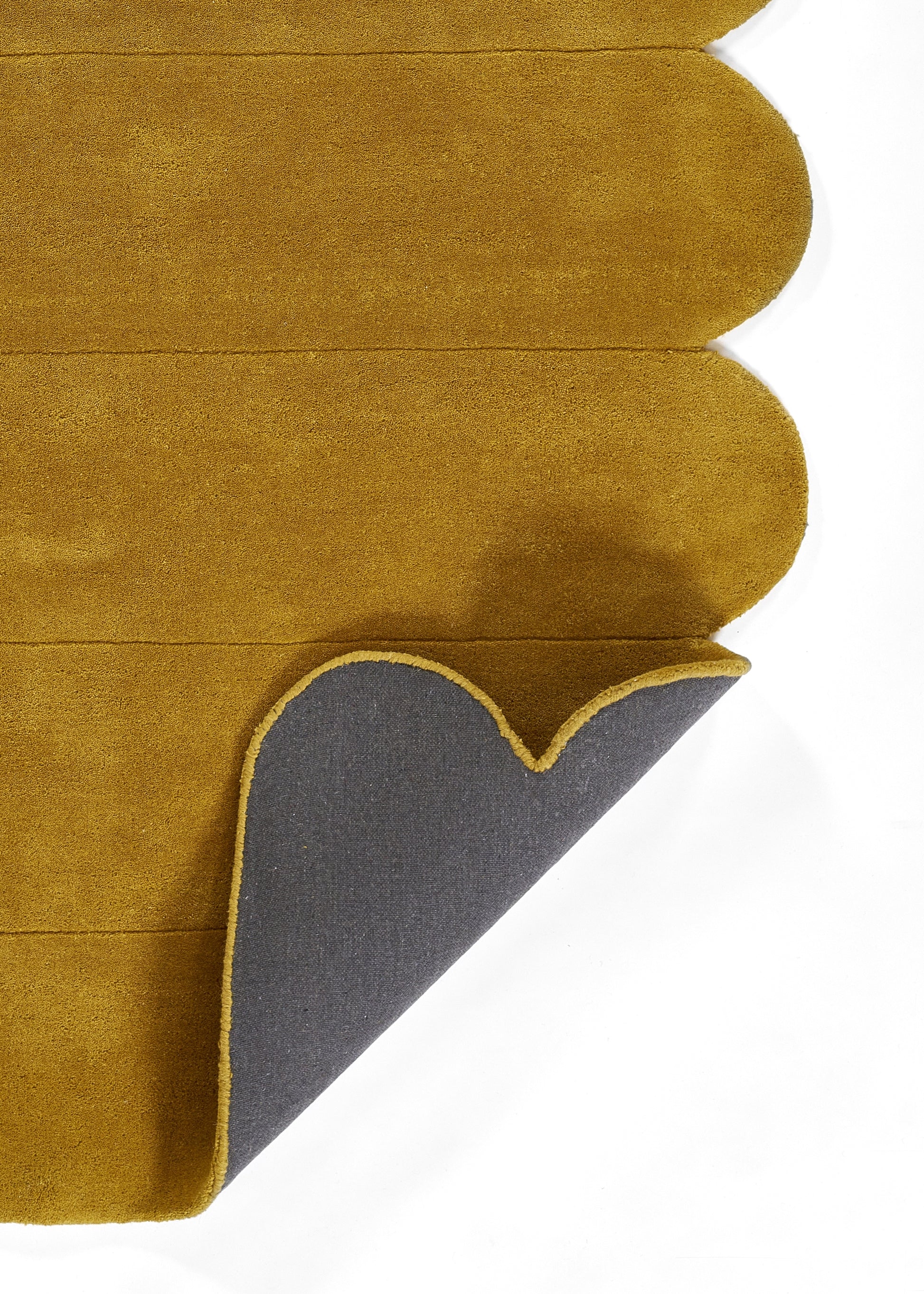 Mustard rug runner with a peeled corner revealing grey backing; 3' x 8'.