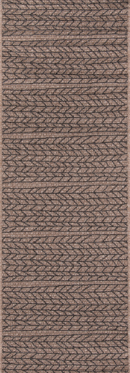 Tan woven rug with geometric chevron pattern and natural fiber texture; versatile floor decor.