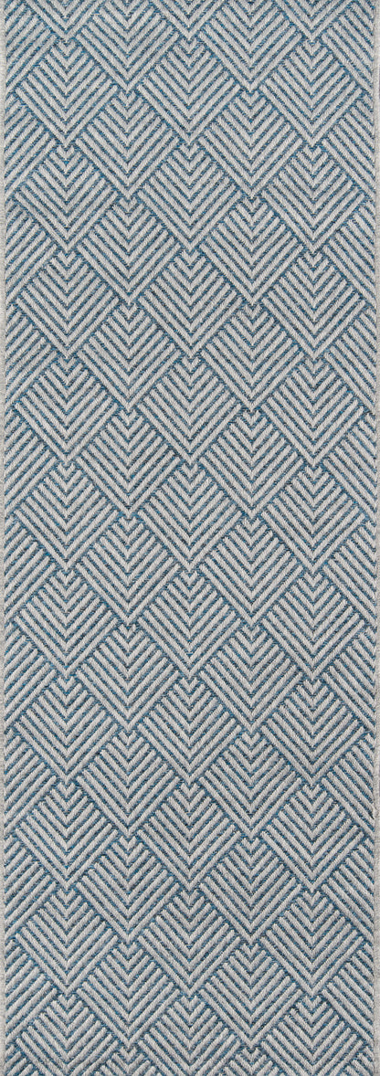 Blue and white geometric chevron rug pattern with repeating diamond shapes and a woven fabric-like texture; 7' x 10' rug.