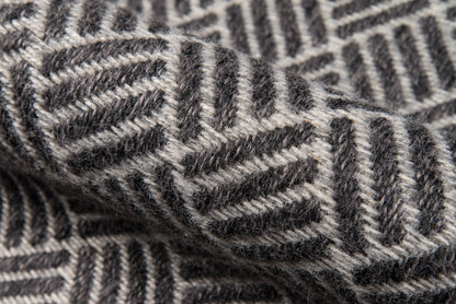 Gray and charcoal herringbone knit wool rug runner with a chevron pattern; cozy textile texture; 2' x 6'.