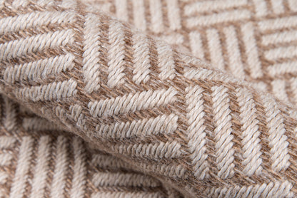 Beige & tan woven wool fabric with chevron pattern; thick textured textile ideal as a cozy throw blanket.