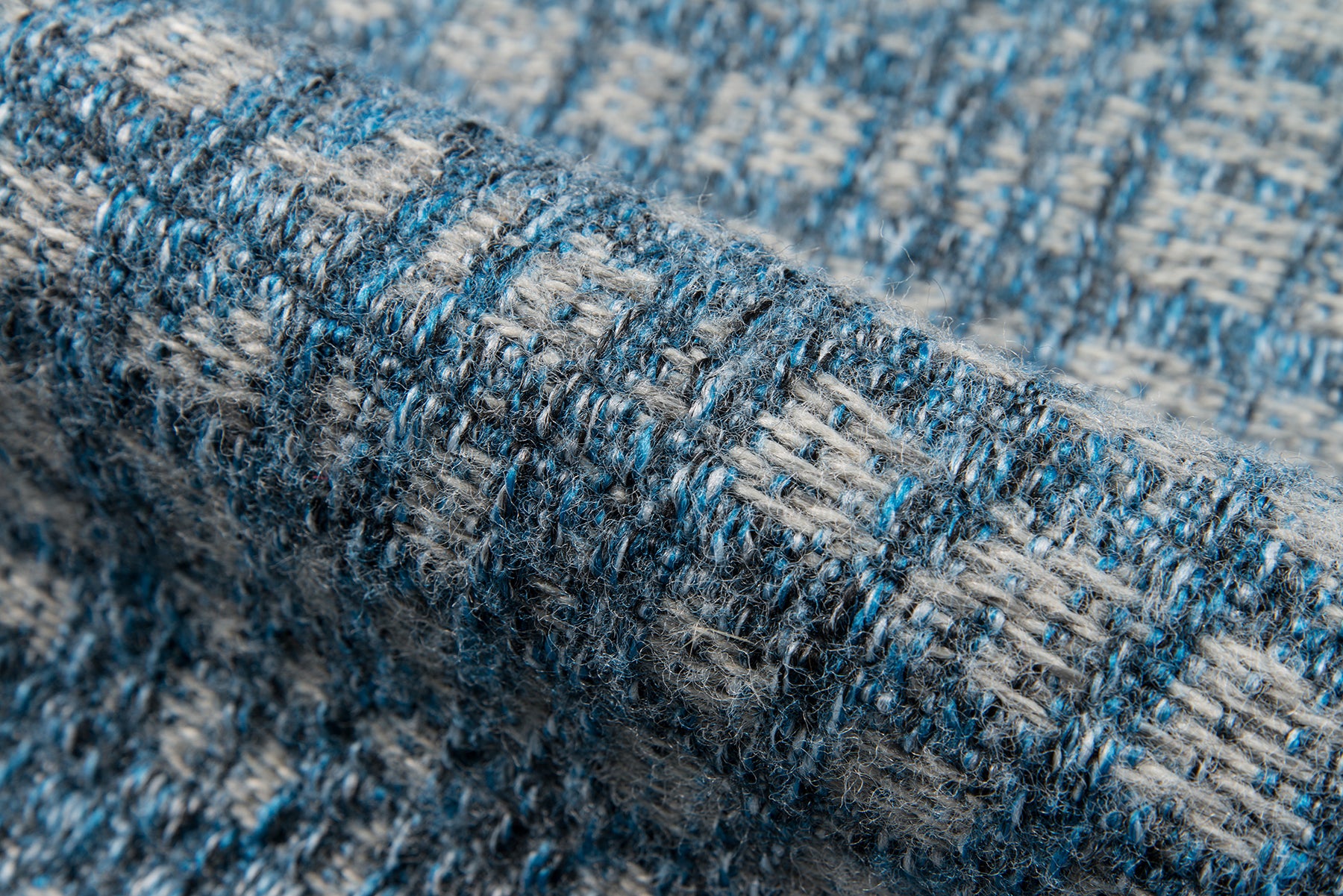 Close-up of blue and gray textured tweed rug with a chunky weave.