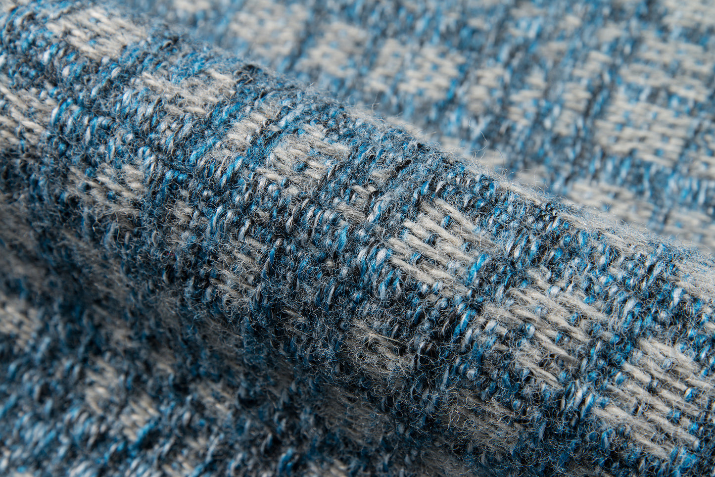 Close-up of blue & gray boucle woven rug with chunky yarns, 10' x 13'.