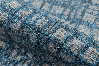 Close-up of blue & gray boucle woven rug with chunky yarns, 10' x 13'.