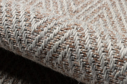 Neutral gray-beige woven rug with a chunky textured weave and chevron pattern.