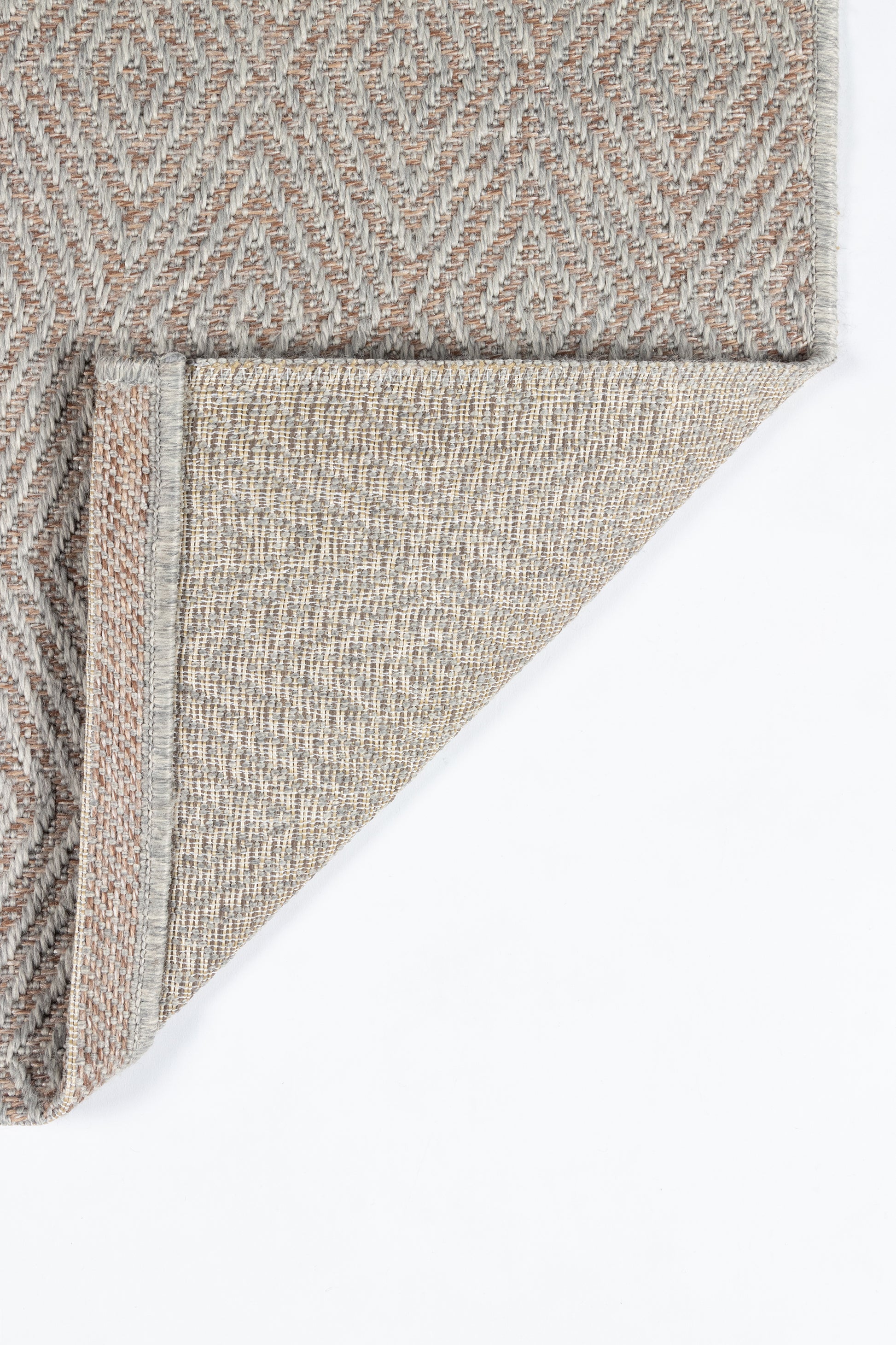 Beige and gray geometric woven rug with diamond motif; folded corner reveals light beige underside.