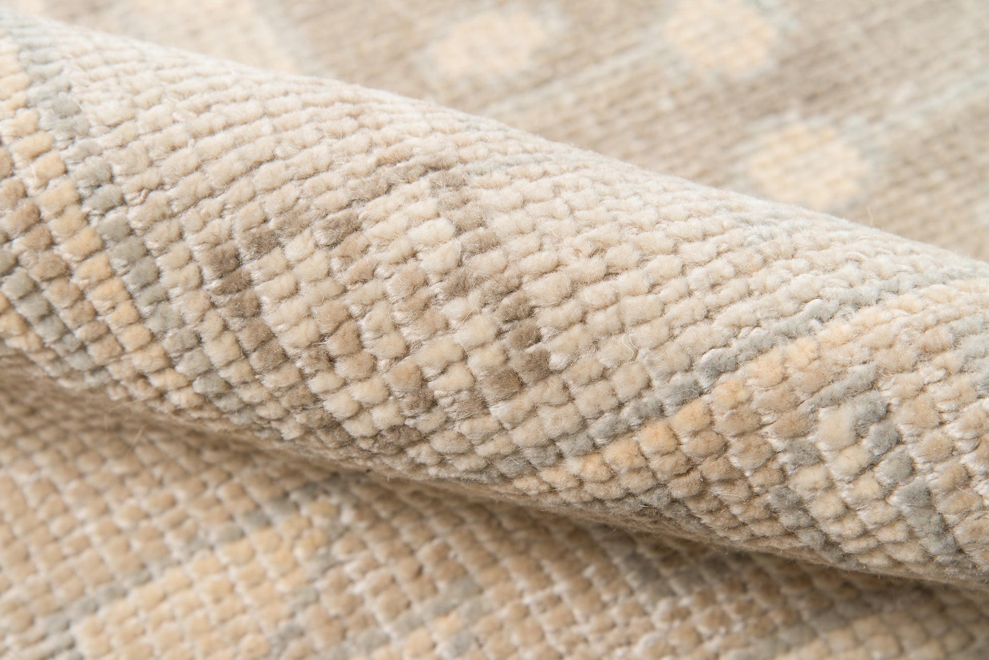 Beige textured woven rug with soft loop pile and subtle striped geometric pattern.