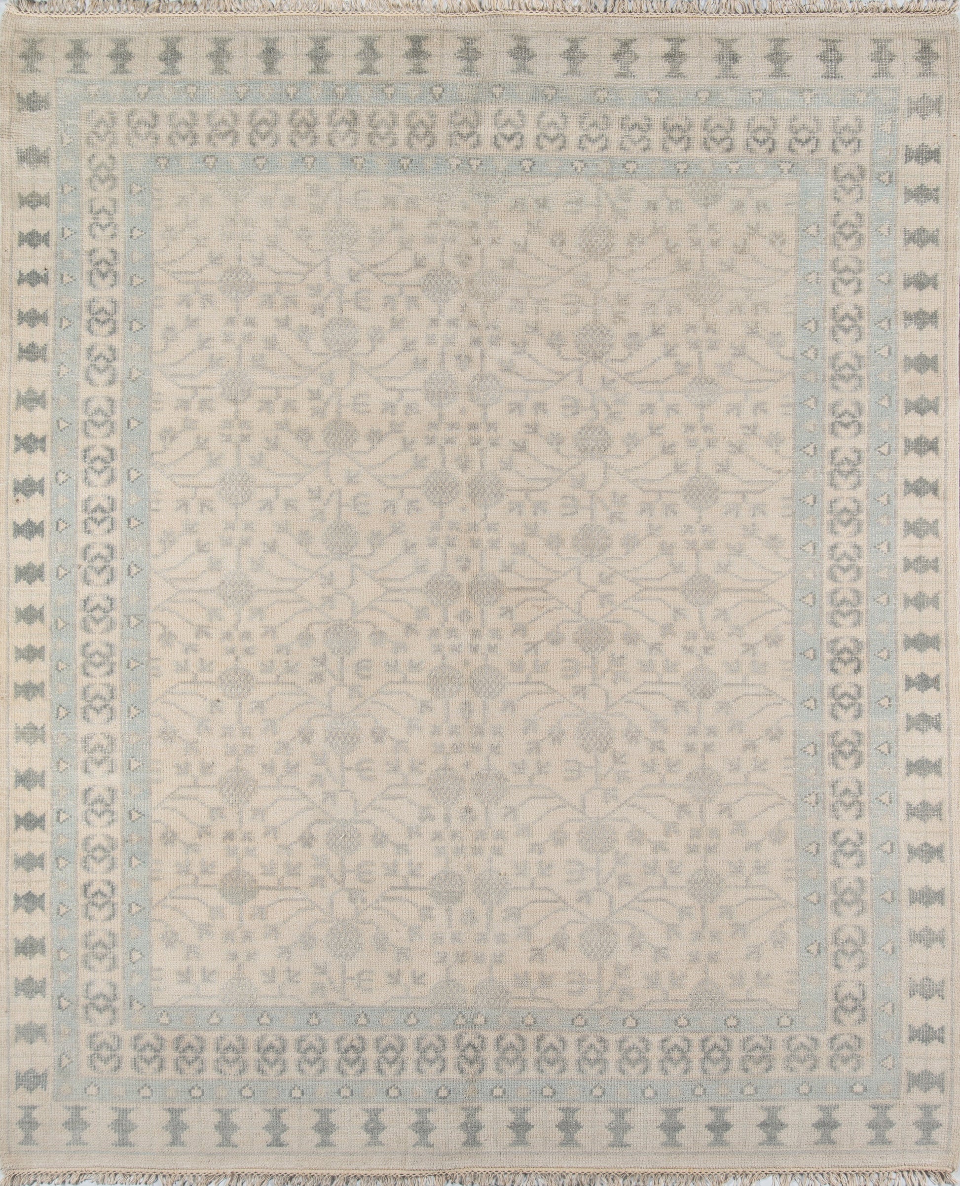Ivory rug with pale blue border and delicate floral damask center; fringed edges.