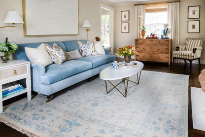 Powder-blue rug with a subtle pattern.