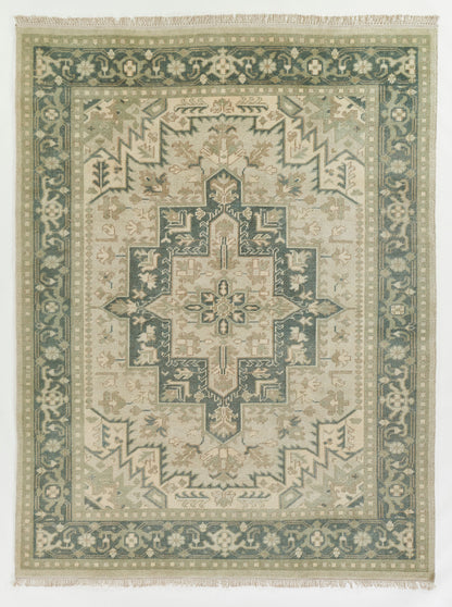 Green & ivory oriental rug with a central geometric medallion, teal border, and fringed ends.