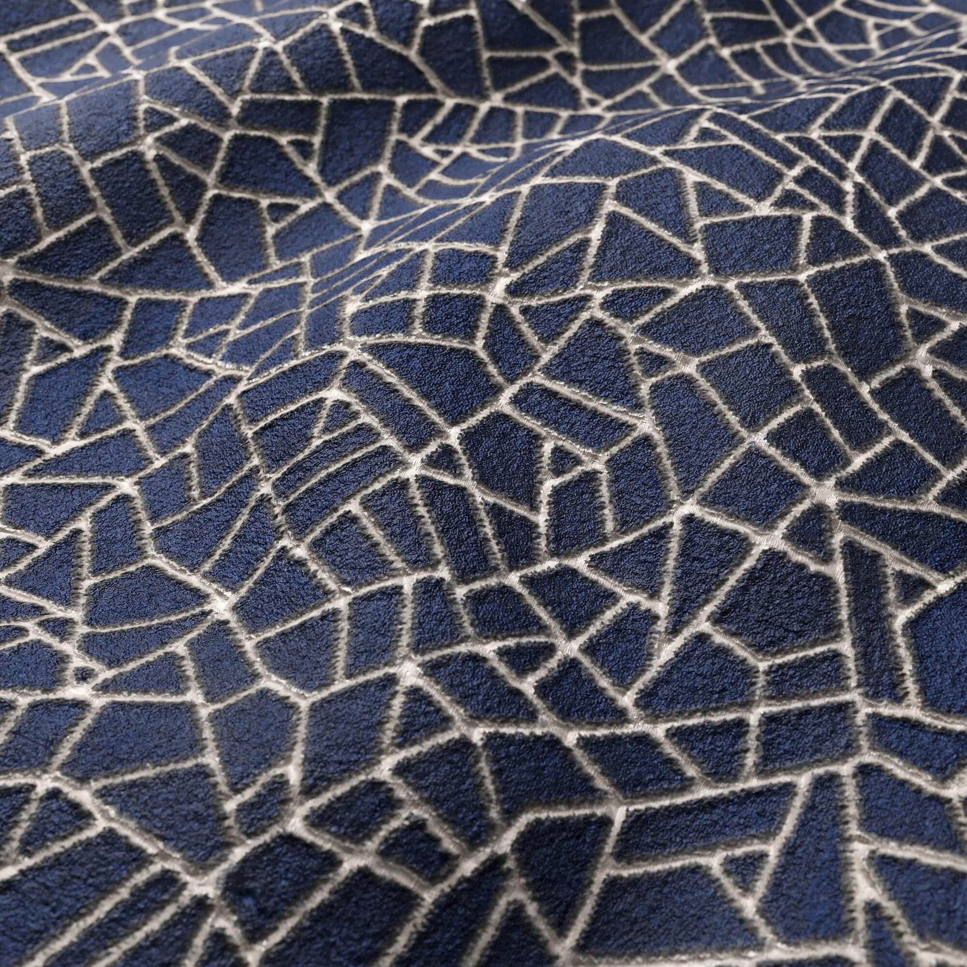 Dark blue textured velvet fabric with a white irregular fractured mosaic pattern.