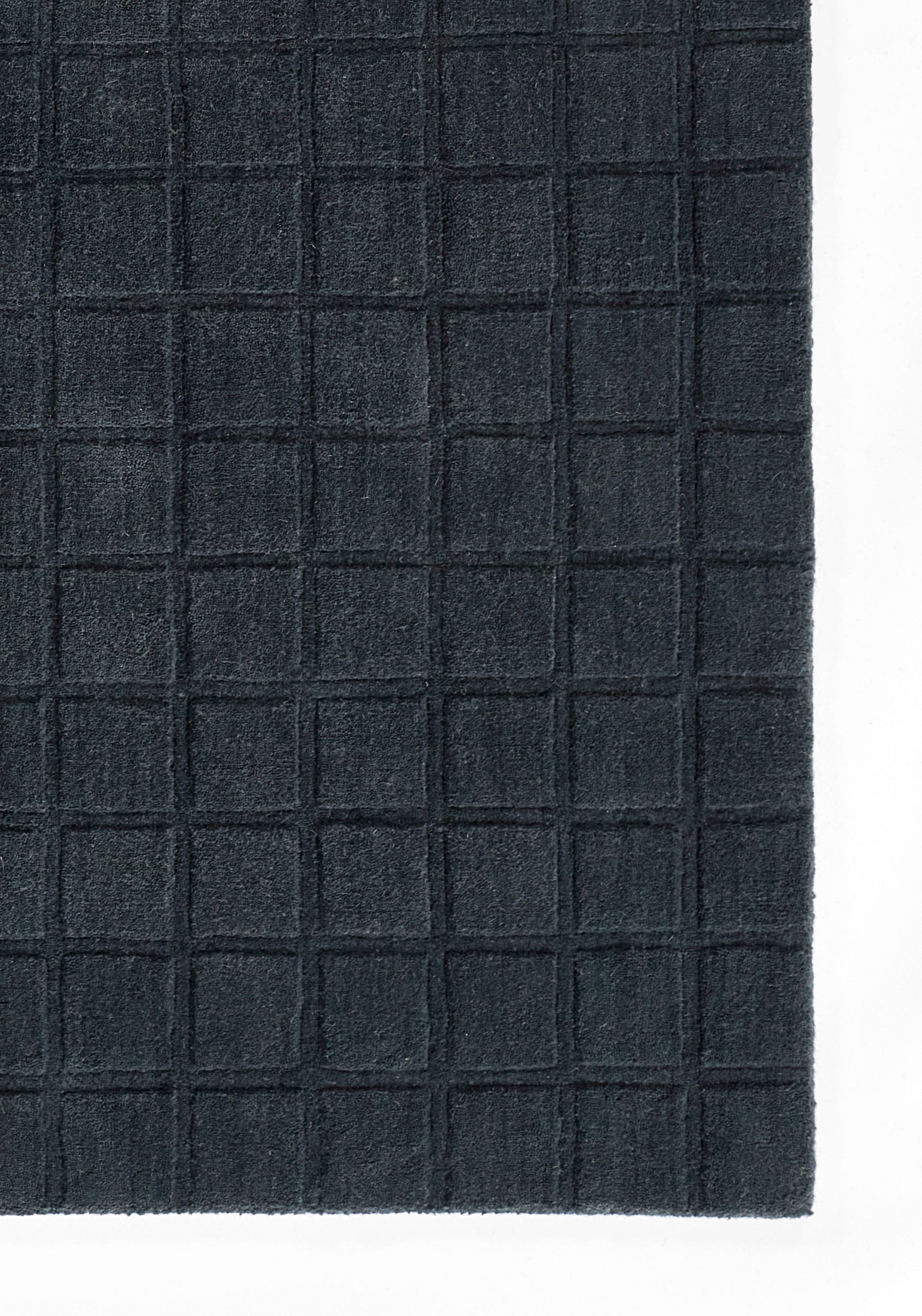 Dark navy rug with a raised square-grid texture; rectangular, modern geometric design
