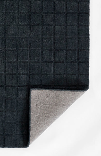 Dark navy waffle-grid textile with square pattern; folded corner reveals light gray underside.