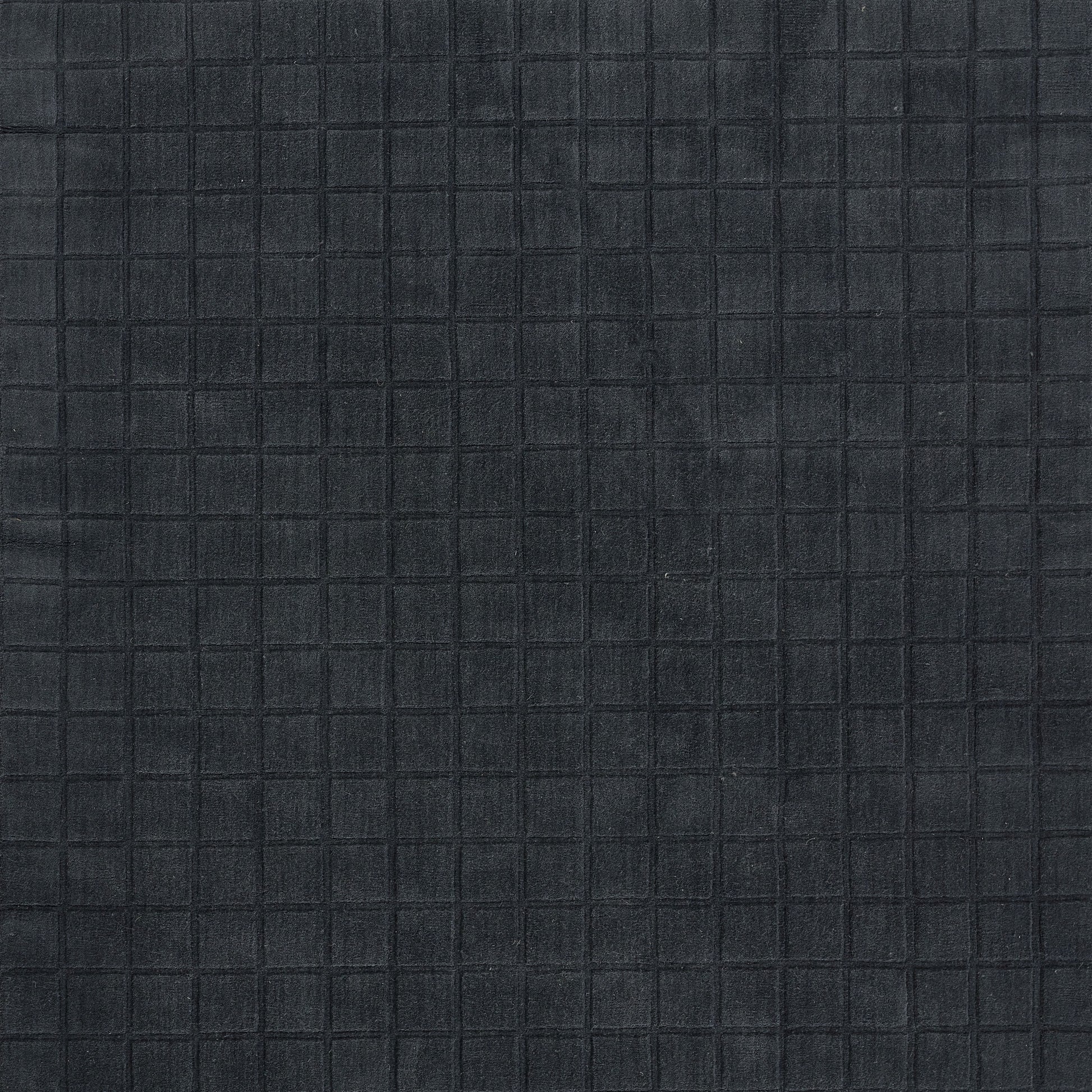 Navy grid-patterned fabric with square stitching, a textured textile suitable for apparel or accessories.
