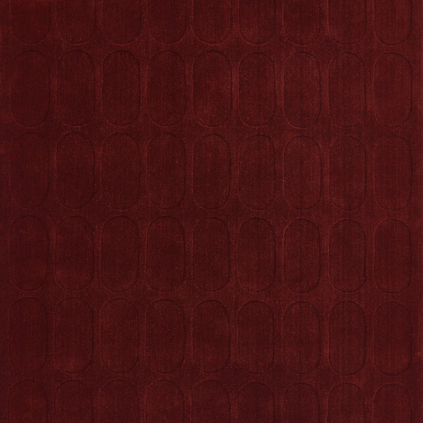 Burgundy rug with a repeating embossed arched-oval pattern and a soft velvet-like texture; 5' x 8'.