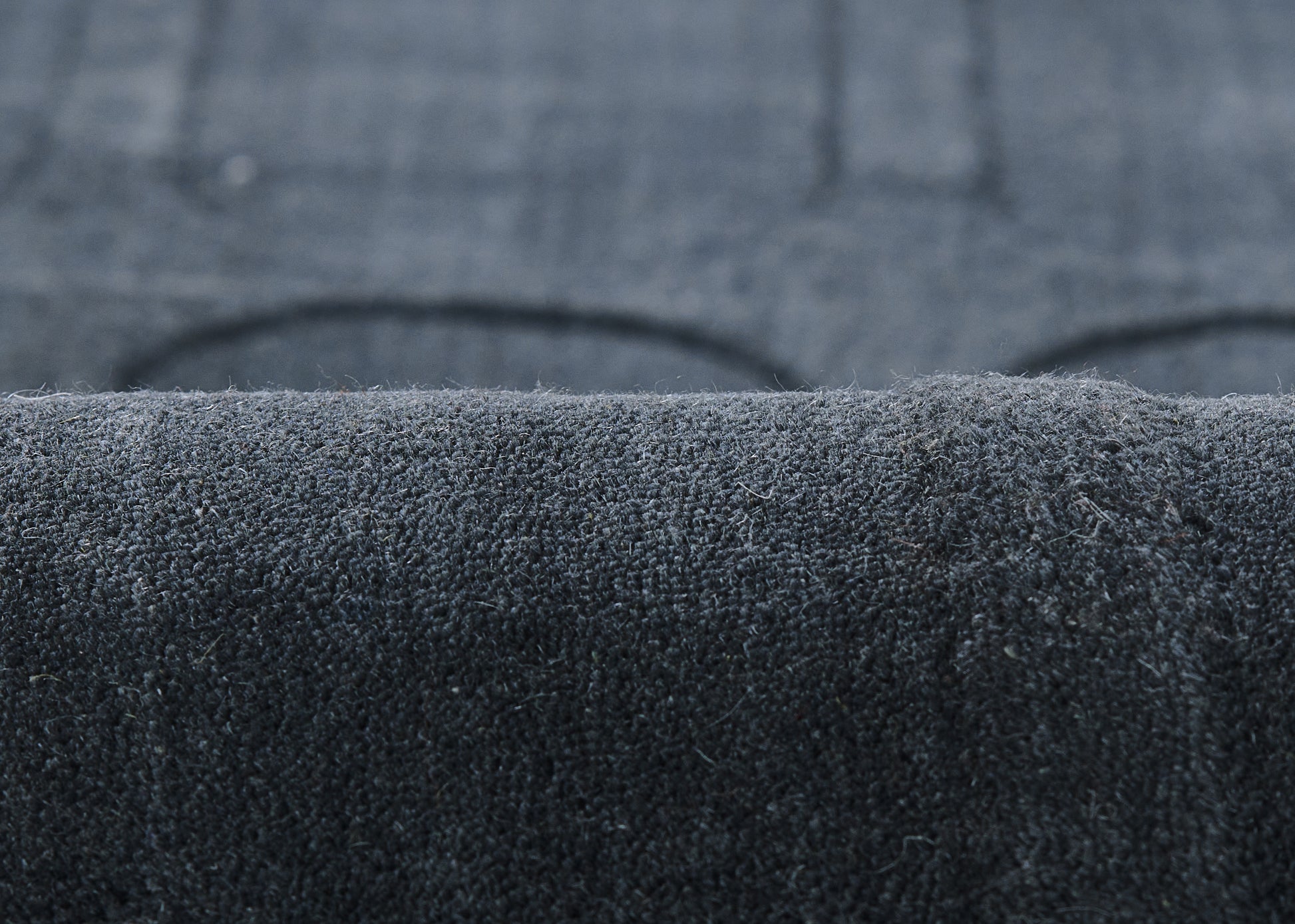 Close-up of dark navy velvet fabric with plush nap, upholstery texture & visible pile.