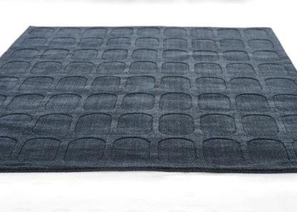 Navy rectangular floor mat with embossed rounded-square grid texture; modern entryway rug.