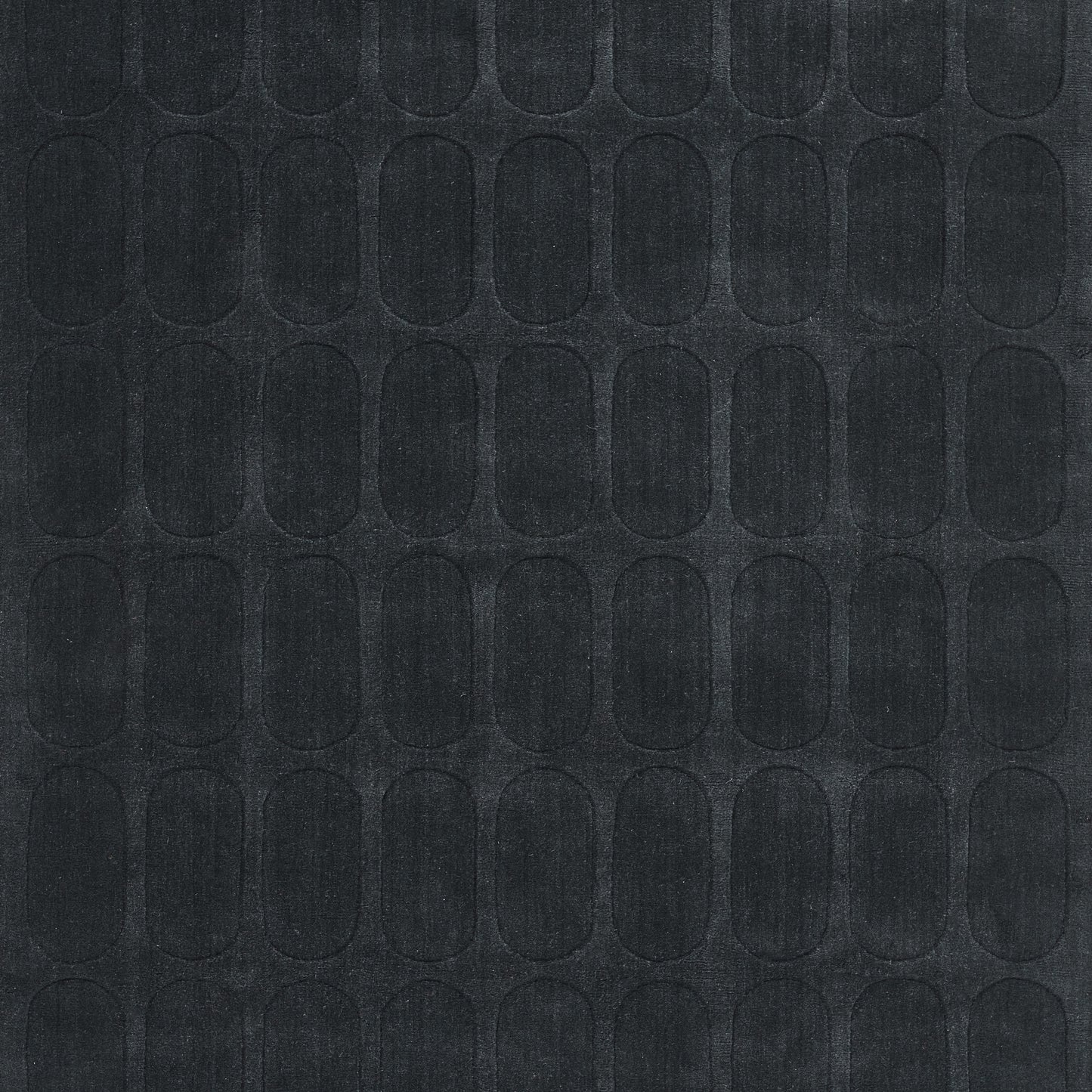 Dark navy rug with a repeating rounded-oval embossed pattern; textured surface with non-slip backing.