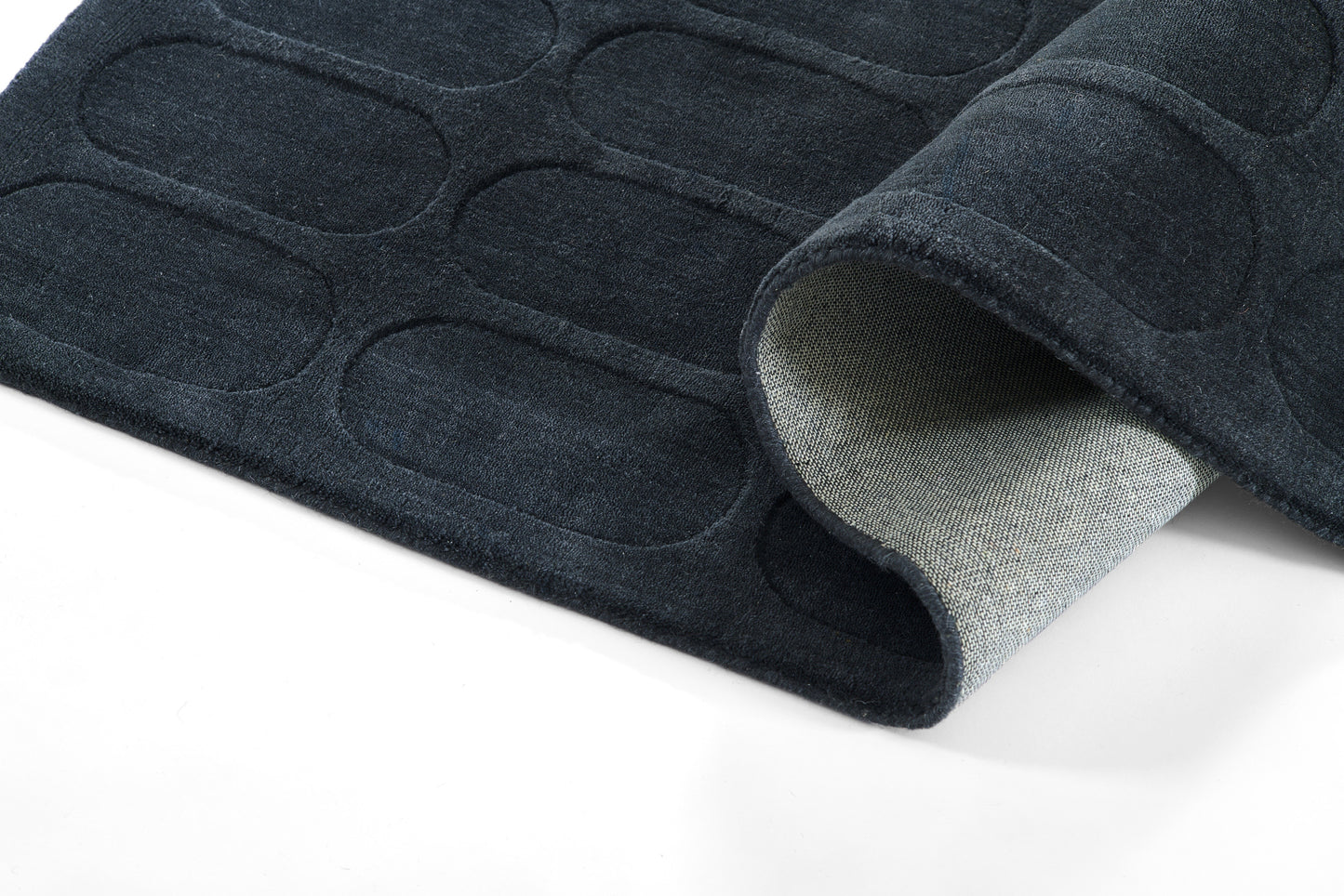 Dark navy contoured floor mat with oval embossed pattern; soft gray underside, rolled edge.