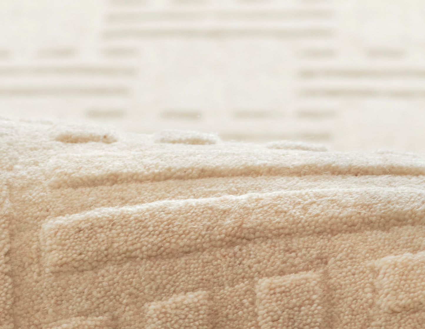Beige plush loop-pile rug with subtle geometric blocks; soft, cozy home decor.