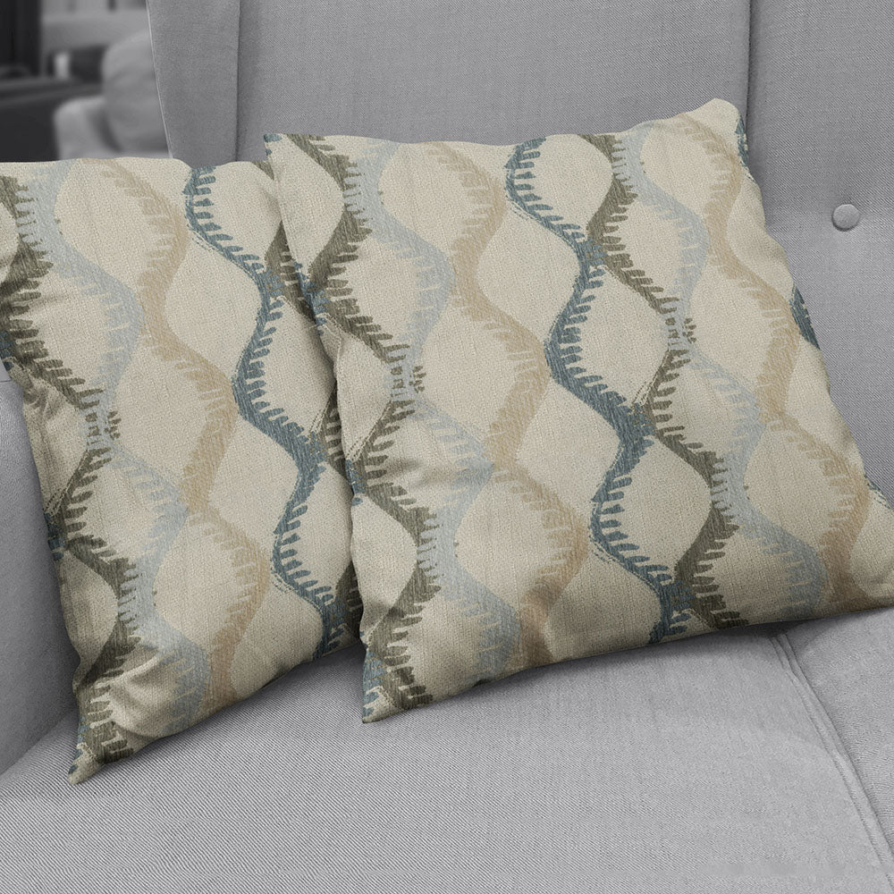 Two square fabric swatches with beige, blue and sage wavy teardrop geometric pattern.