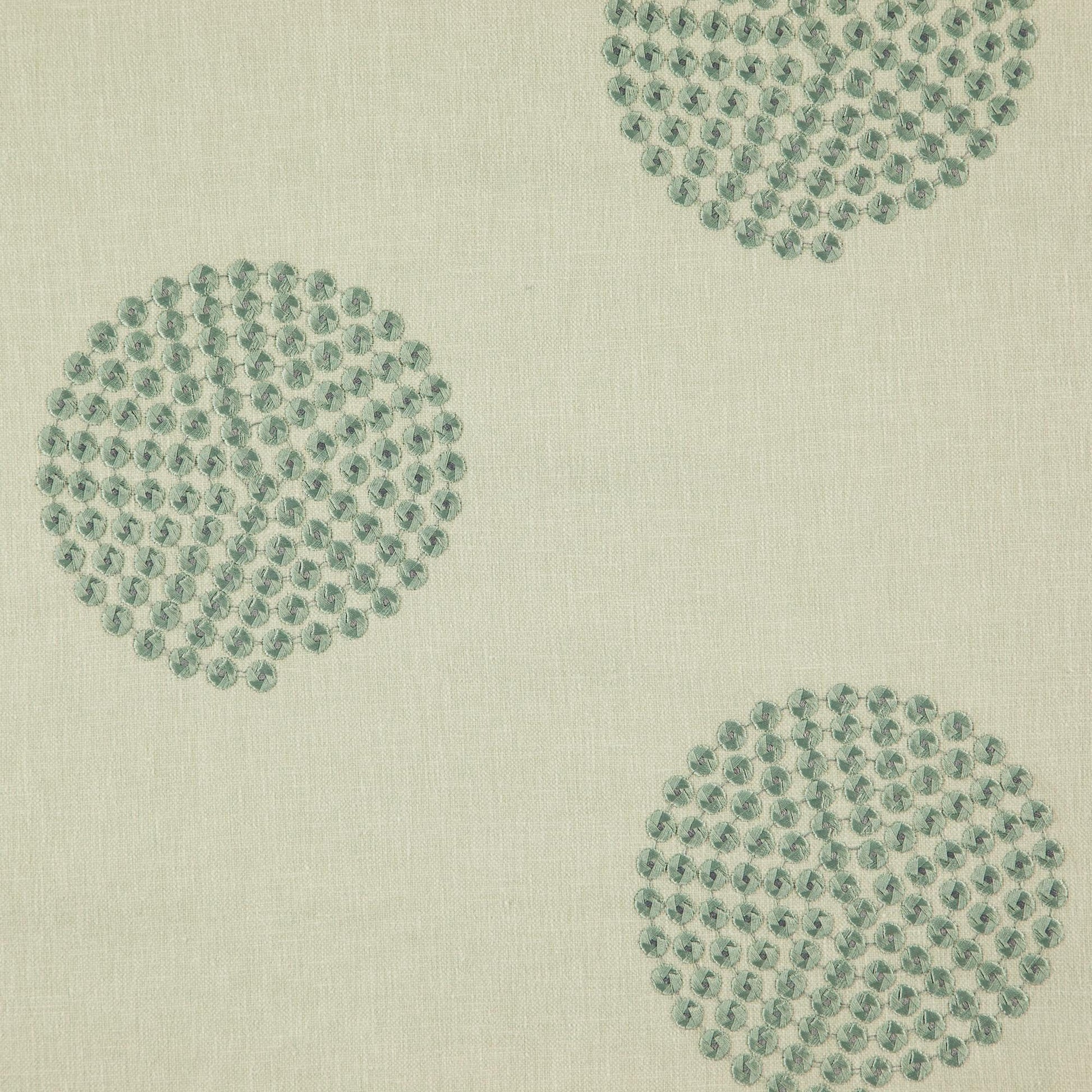 Fabric with geometric green embroidery texture; upholstery material.