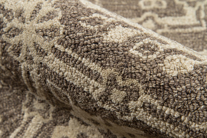 Brown and beige tufted rug with plush pile and geometric motifs, Persian-inspired.