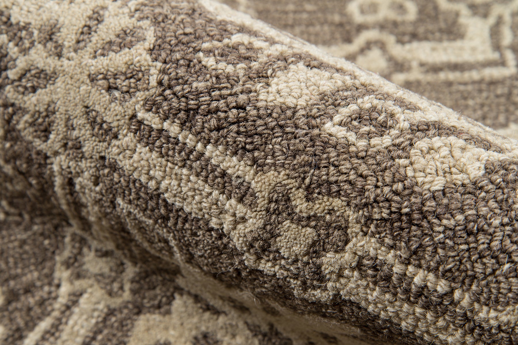 Brown & beige oriental-patterned rug with plush, textured pile and geometric motifs; cozy home decor.