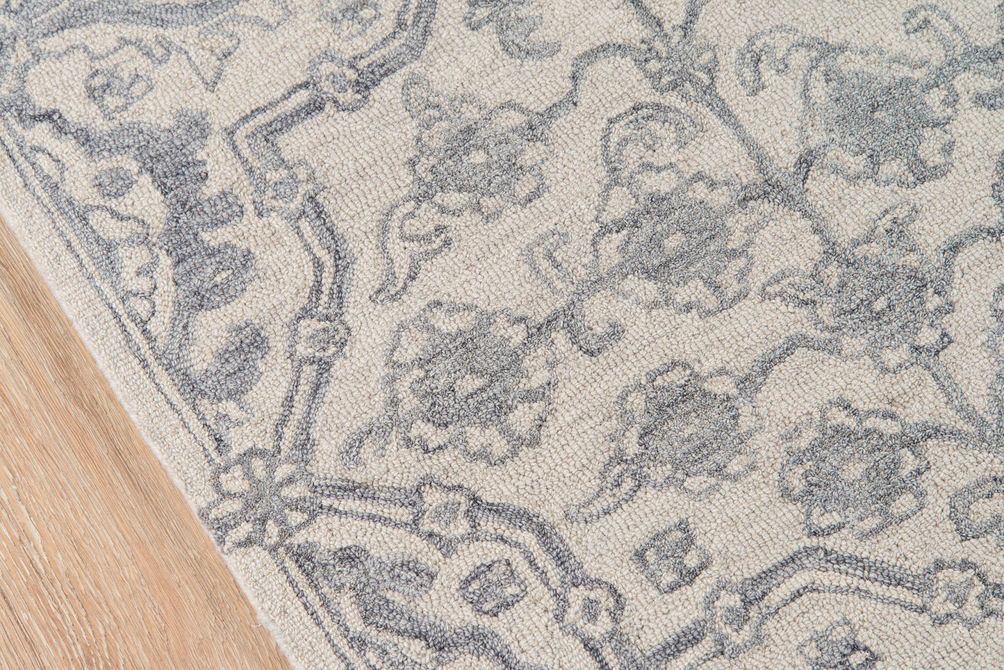 Rectangular gray damask rug on light ivory; soft woven texture, decorative living room accent.