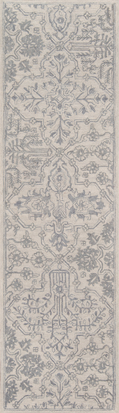 Rectangular area rug in ivory and gray with an ornate oriental-inspired floral/arabesque pattern.